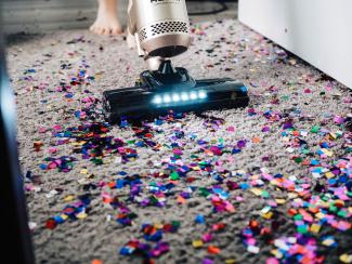 a person using a vacuum to clean a carpet by No Revisions courtesy of Unsplash.
